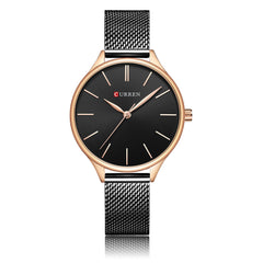Wristwatch with a black face in rose gold casing with a mesh silver band on a white background