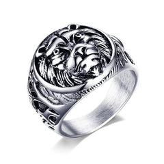 Silver ring with intricate design on a white background