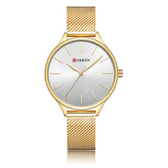 Rose gold watch and mesh band with a white face on a white background