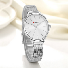 Silver Curren watch and mesh band with a white face on a light background